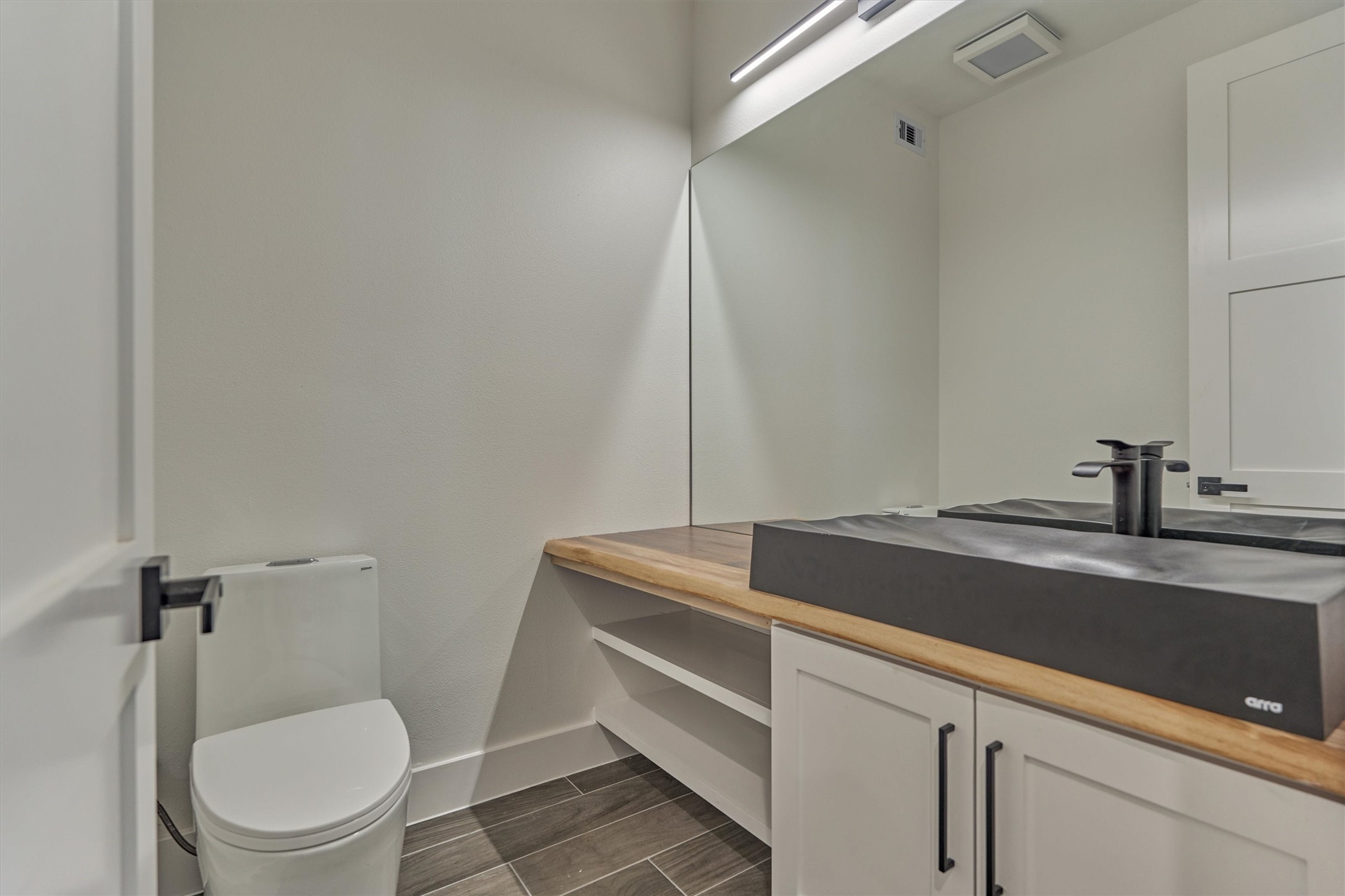 2811 Hemingway Drive Montgomery, TX 77356 - Photo 24 of 50 a bathroom with a granite countertop sink toilet and mirror