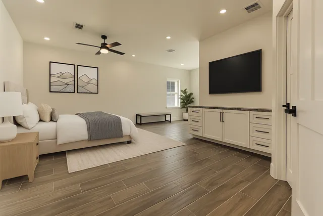 an empty room with wooden floor cabinet and windows