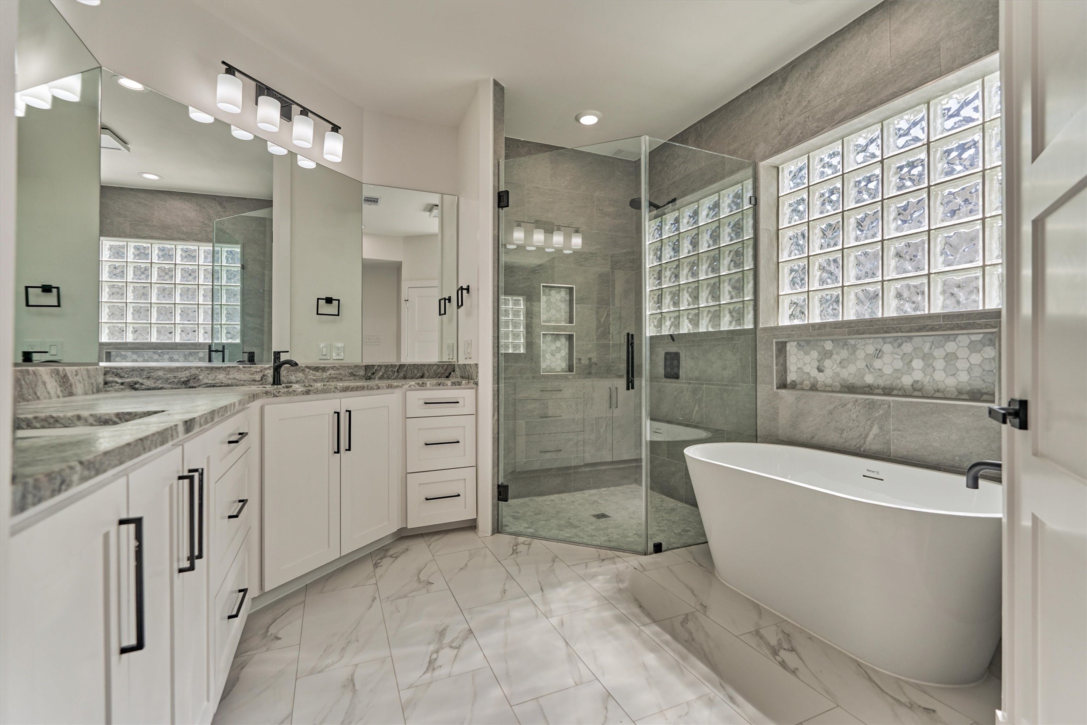 2811 Hemingway Drive Montgomery, TX 77356 - Photo 30 of 50 a spacious bathroom with a granite countertop tub sink a mirror a shower and vanity