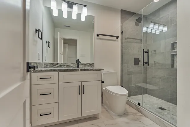 a spacious bedroom with a bed and a chandelier