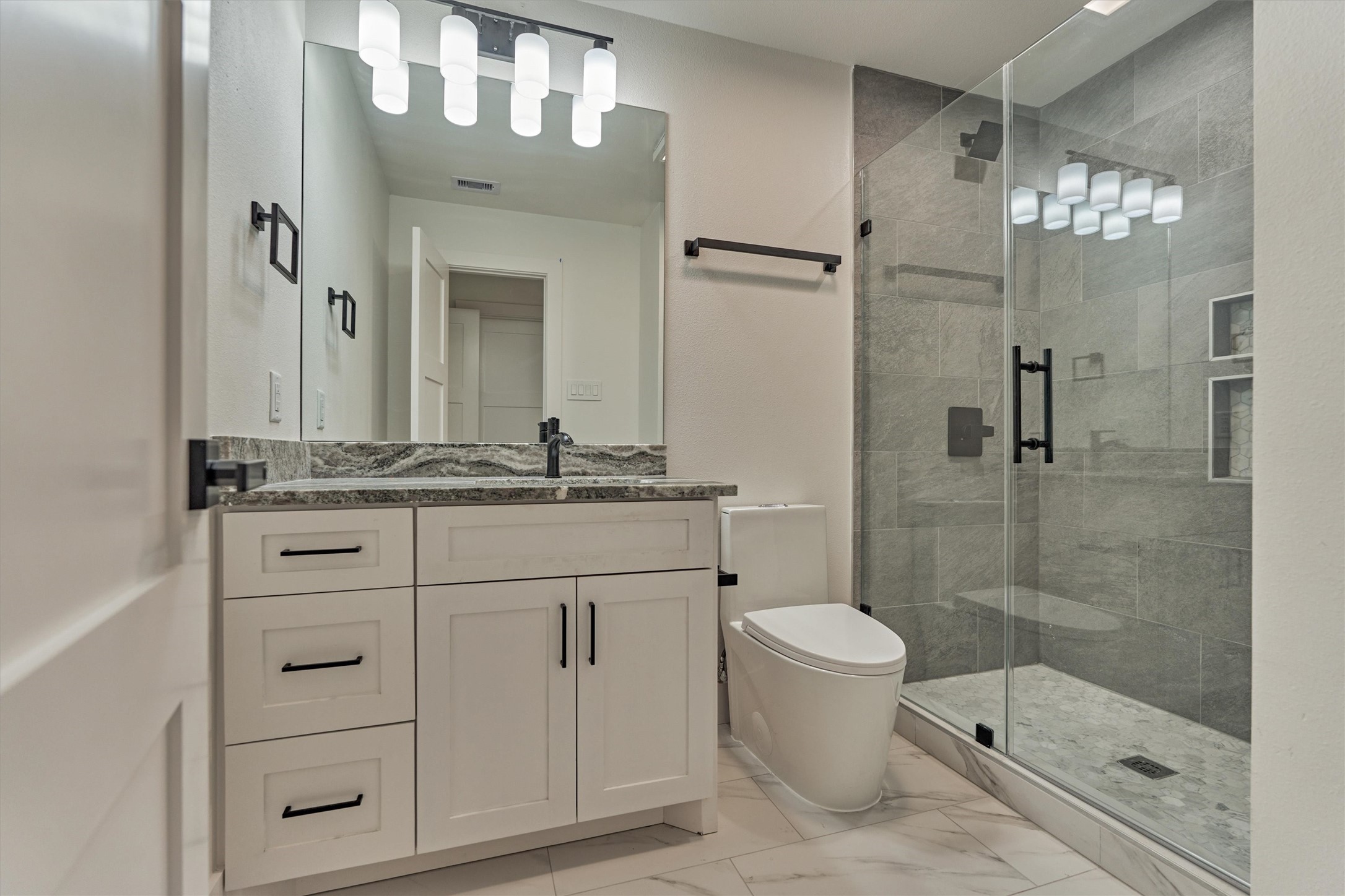 2811 Hemingway Drive Montgomery, TX 77356 - Photo 36 of 50 a bathroom with a granite countertop sink toilet and shower