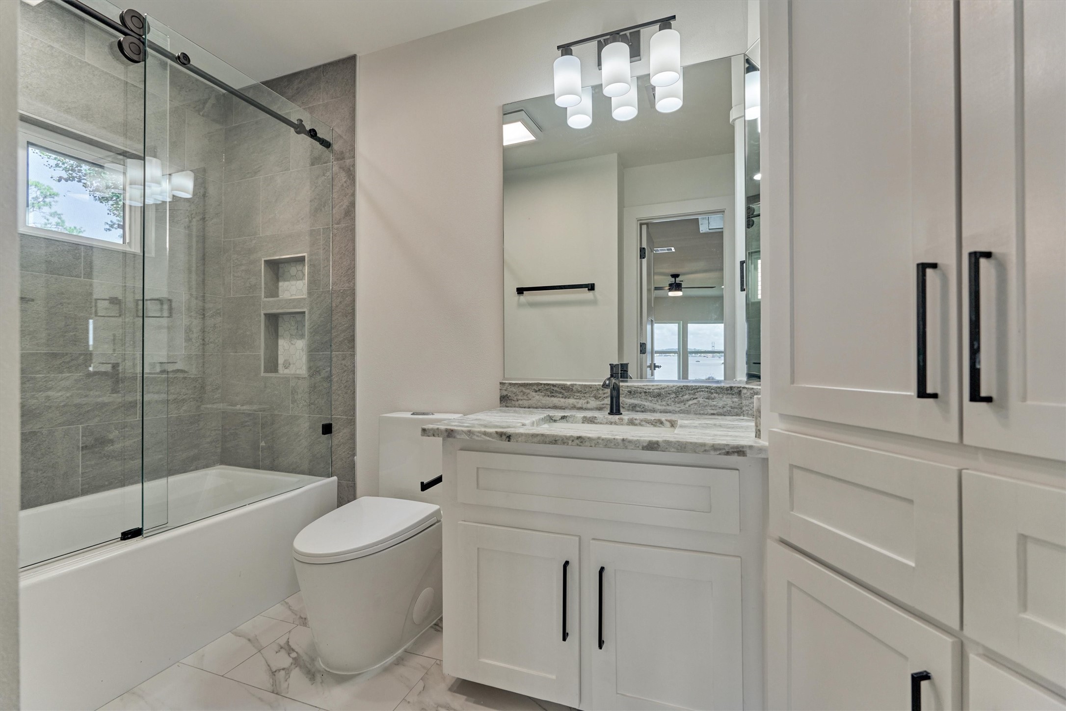 2811 Hemingway Drive Montgomery, TX 77356 - Photo 39 of 50 a bathroom with a granite countertop sink a toilet and shower