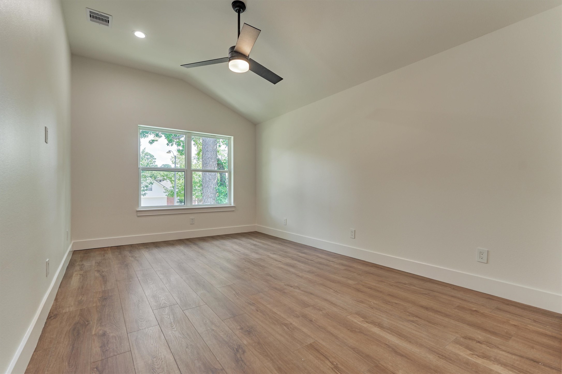 2811 Hemingway Drive Montgomery, TX 77356 - Photo 41 of 50 an empty room with wooden floor chandelier fan and windows