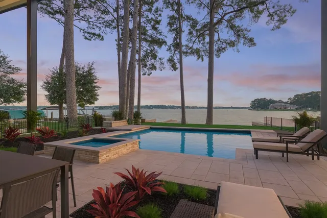 a view of a swimming pool with lounge chairs in the patio