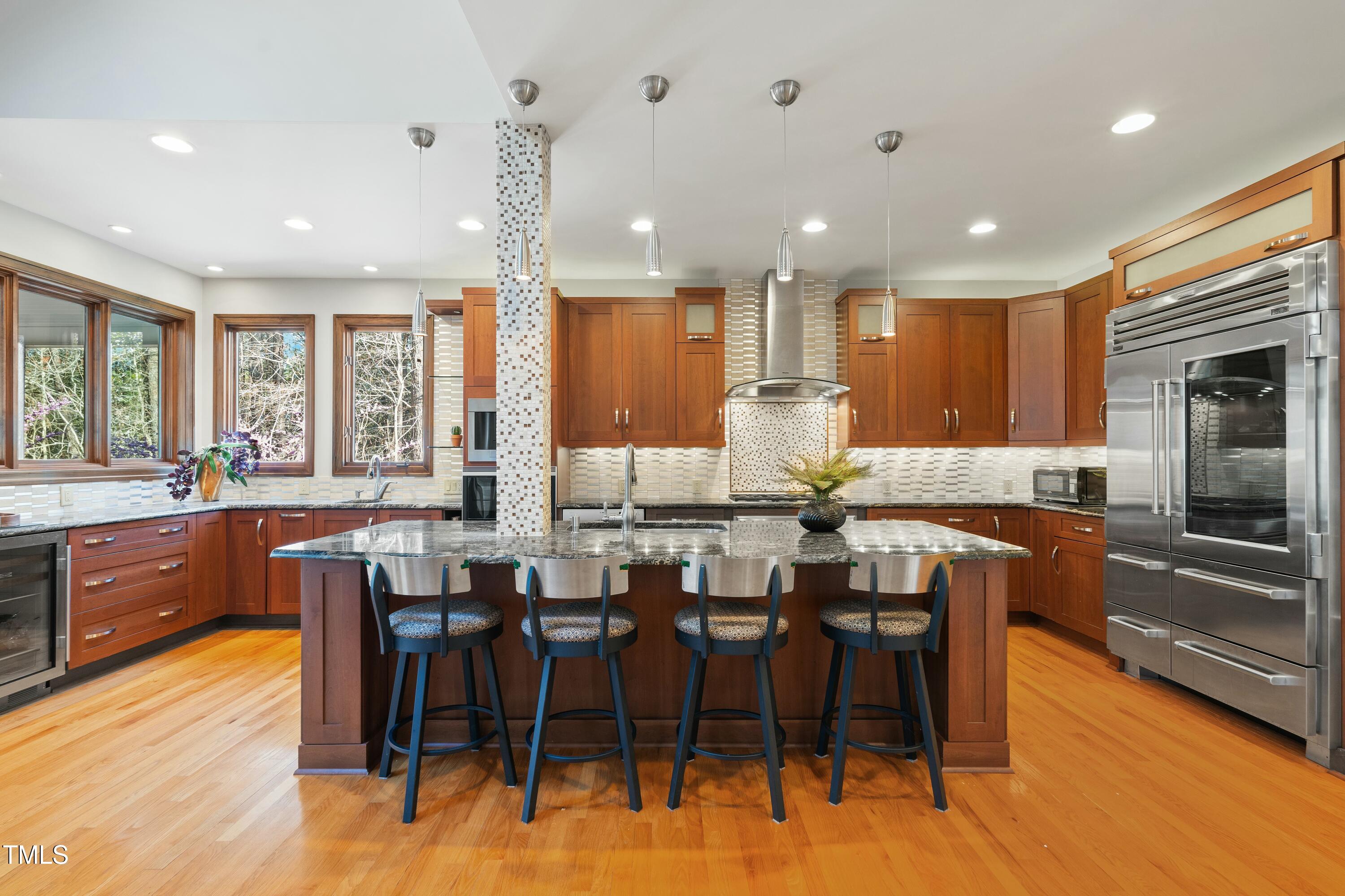 12117 Cliffside Circle Raleigh, NC 27614 - Photo 18 of 63 a large kitchen with lots of table and chairs