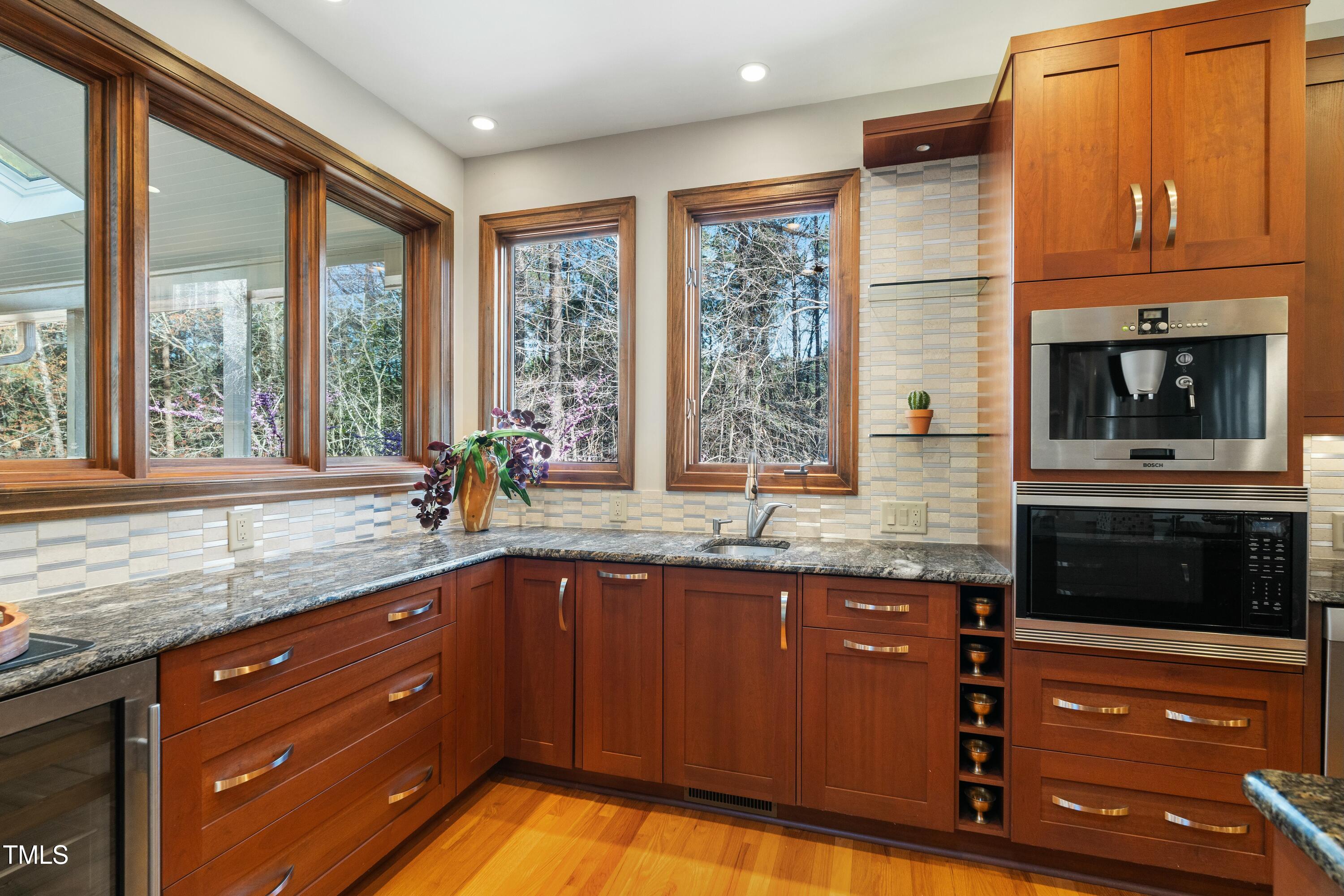 12117 Cliffside Circle Raleigh, NC 27614 - Photo 19 of 63 a kitchen with granite countertop a sink and a stove