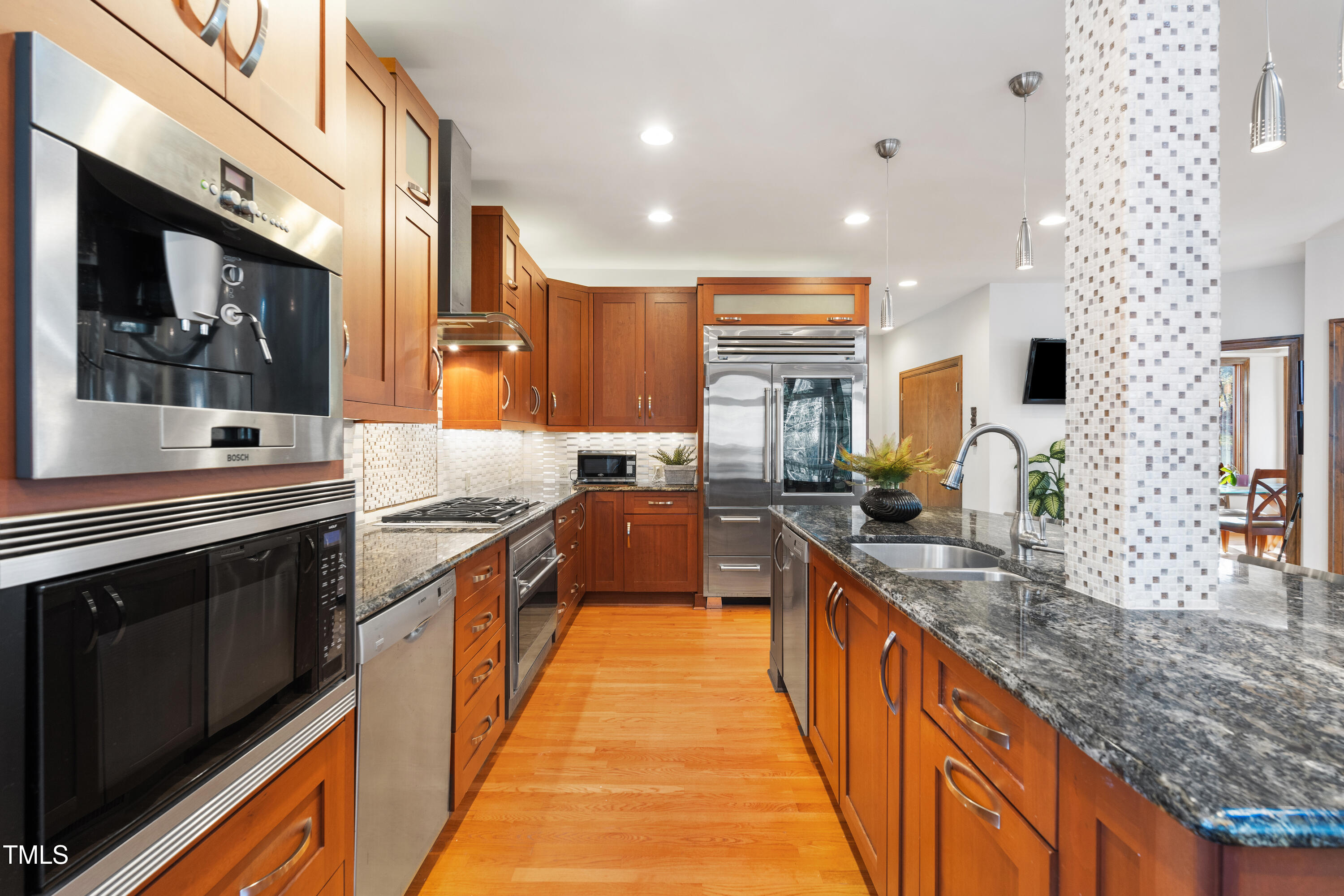 12117 Cliffside Circle Raleigh, NC 27614 - Photo 20 of 63 a large kitchen with stainless steel appliances granite countertop a lot of counter space and wooden floor