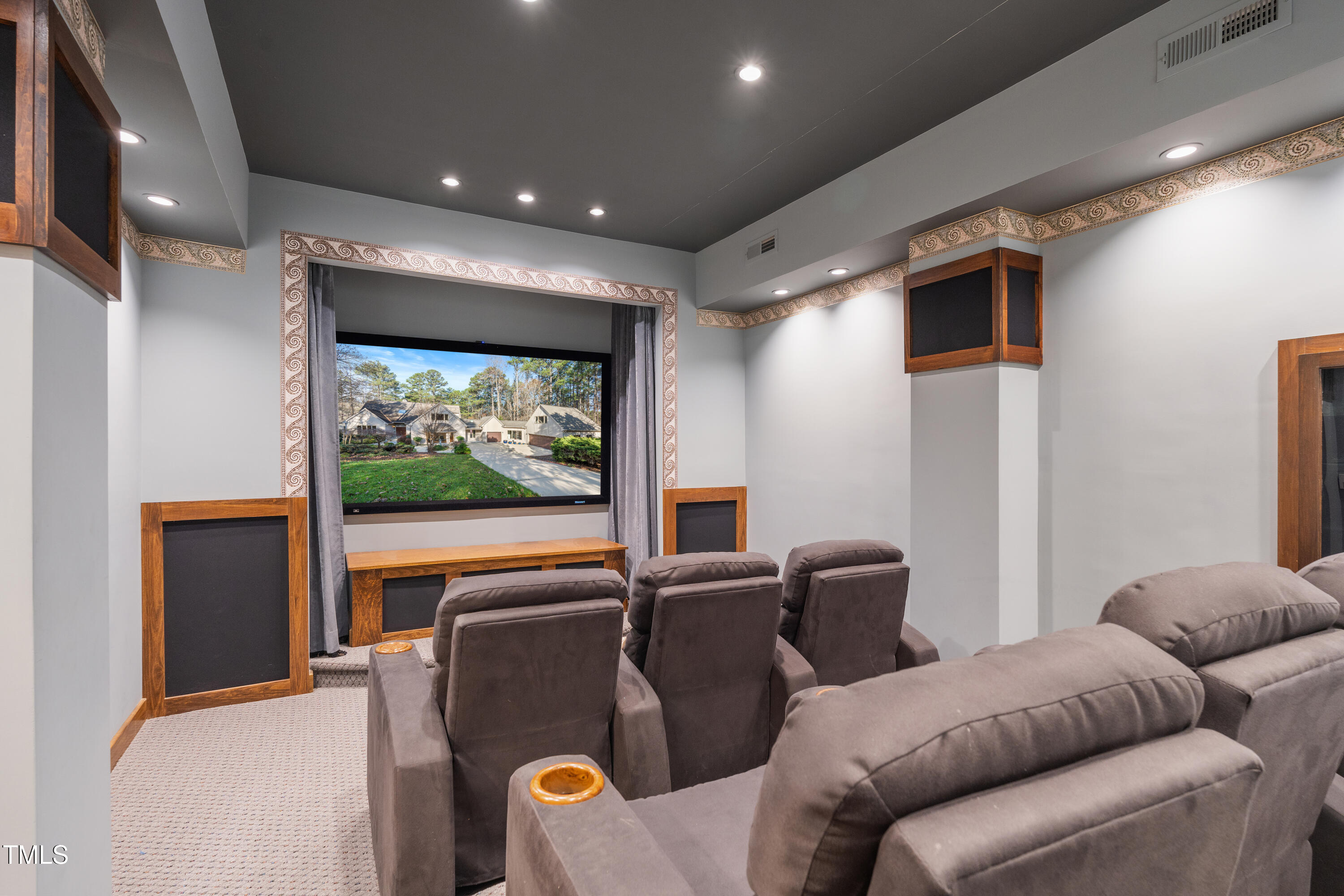 12117 Cliffside Circle Raleigh, NC 27614 - Photo 27 of 63 a projector room with furniture and a flat screen tv