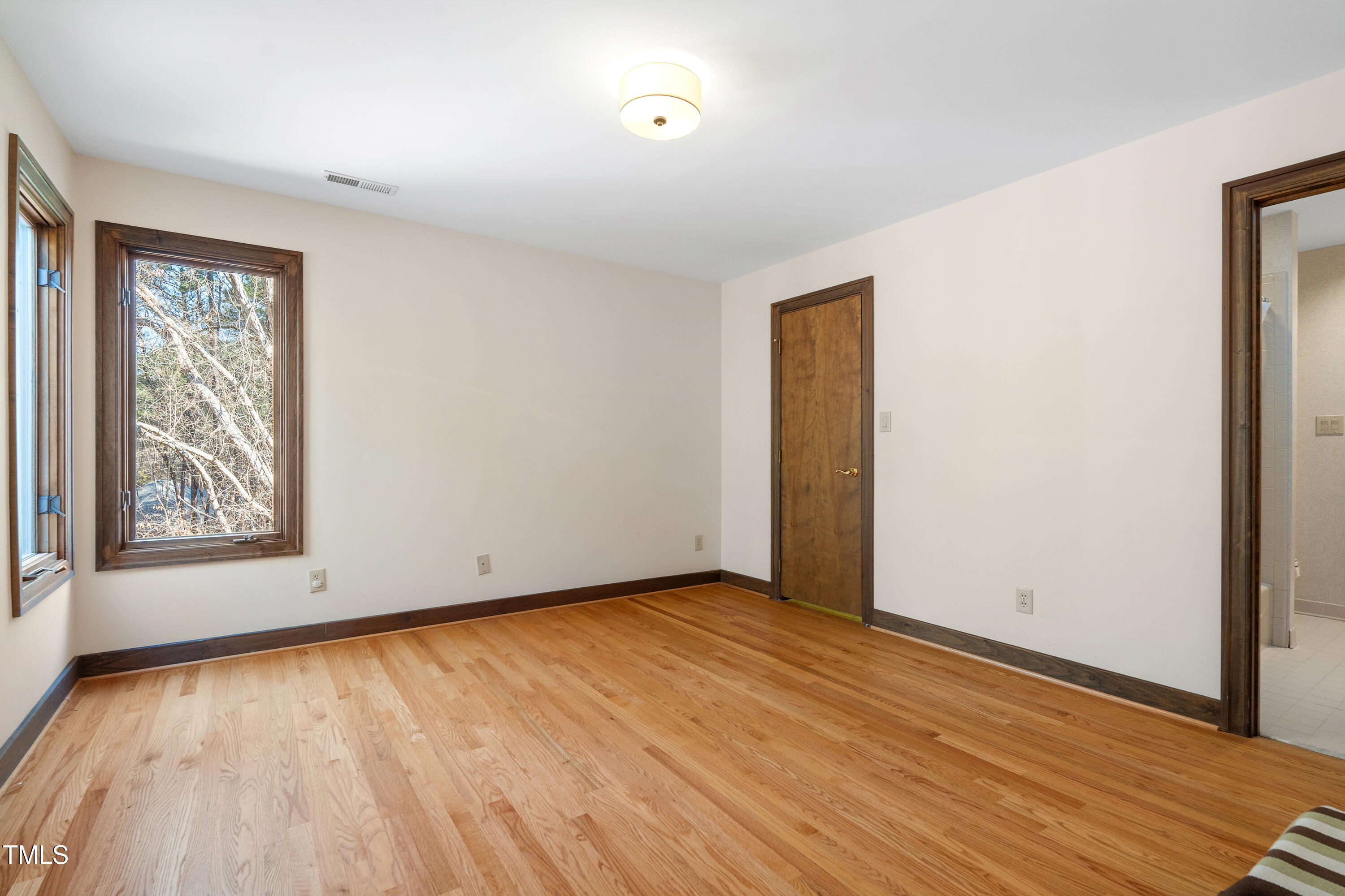 12117 Cliffside Circle Raleigh, NC 27614 - Photo 38 of 63 a view of an empty room with wooden floor and a window