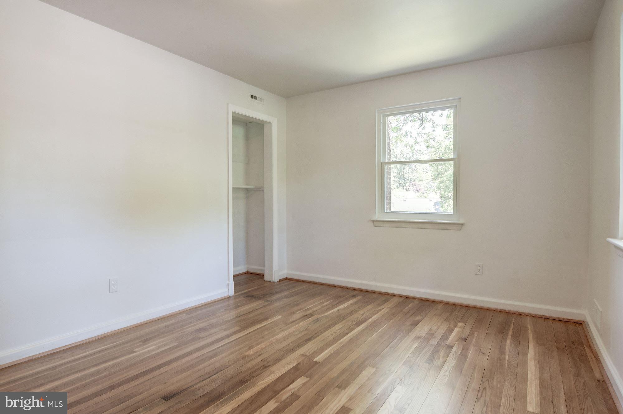 2901 Ivydale Street Silver Spring, MD 20902 - Photo 14 of 27 an empty room with wooden floor and windows
