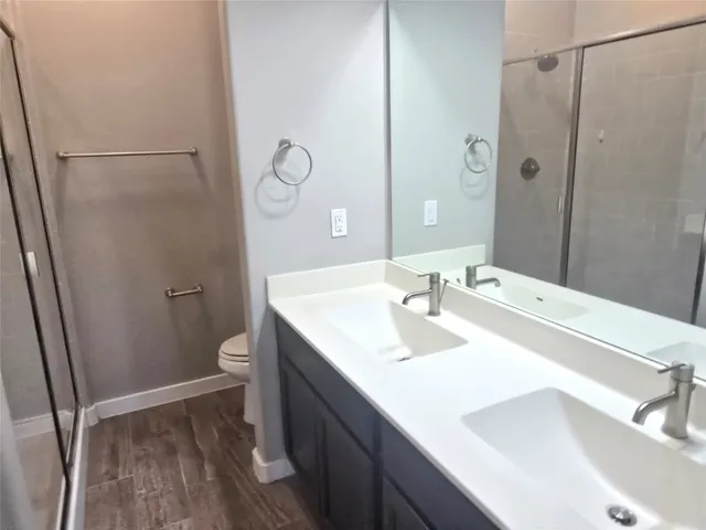 a bathroom with a sink toilet and shower
