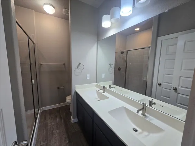 a bathroom with double vanity sink and a mirror