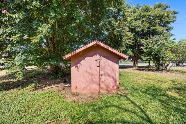 a view of a wooden house with a yard