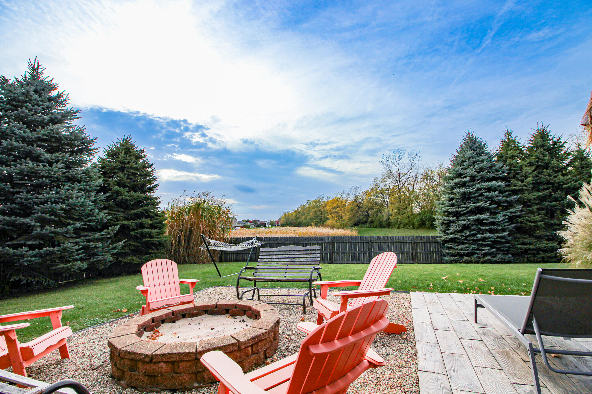 1403 Edgewater Road Crown Point, IN 46307 - Photo 4 of 43 a view of table and chairs with wooden fence