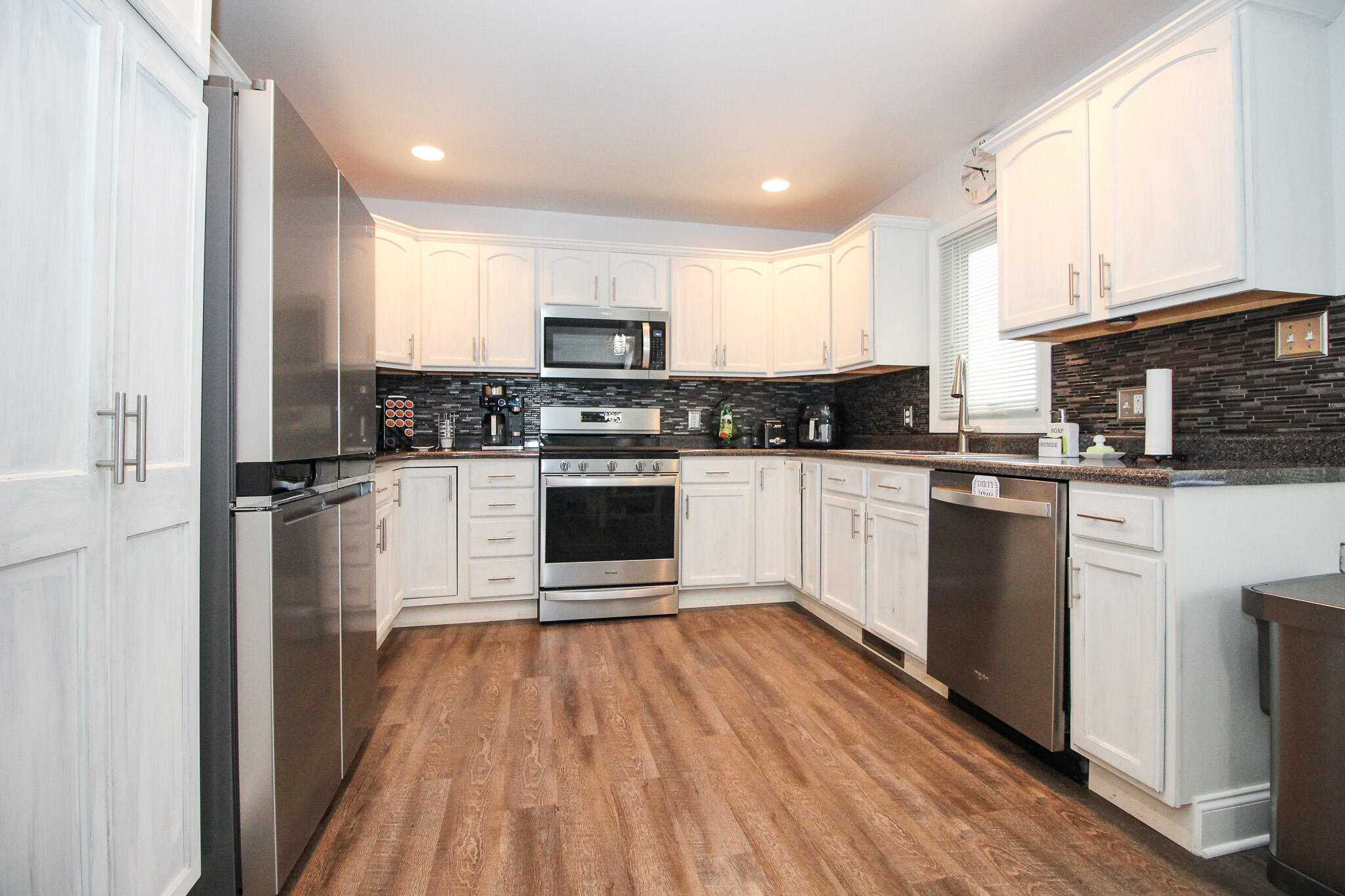 1403 Edgewater Road Crown Point, IN 46307 - Photo 7 of 43 a kitchen with cabinets a sink and steel appliances