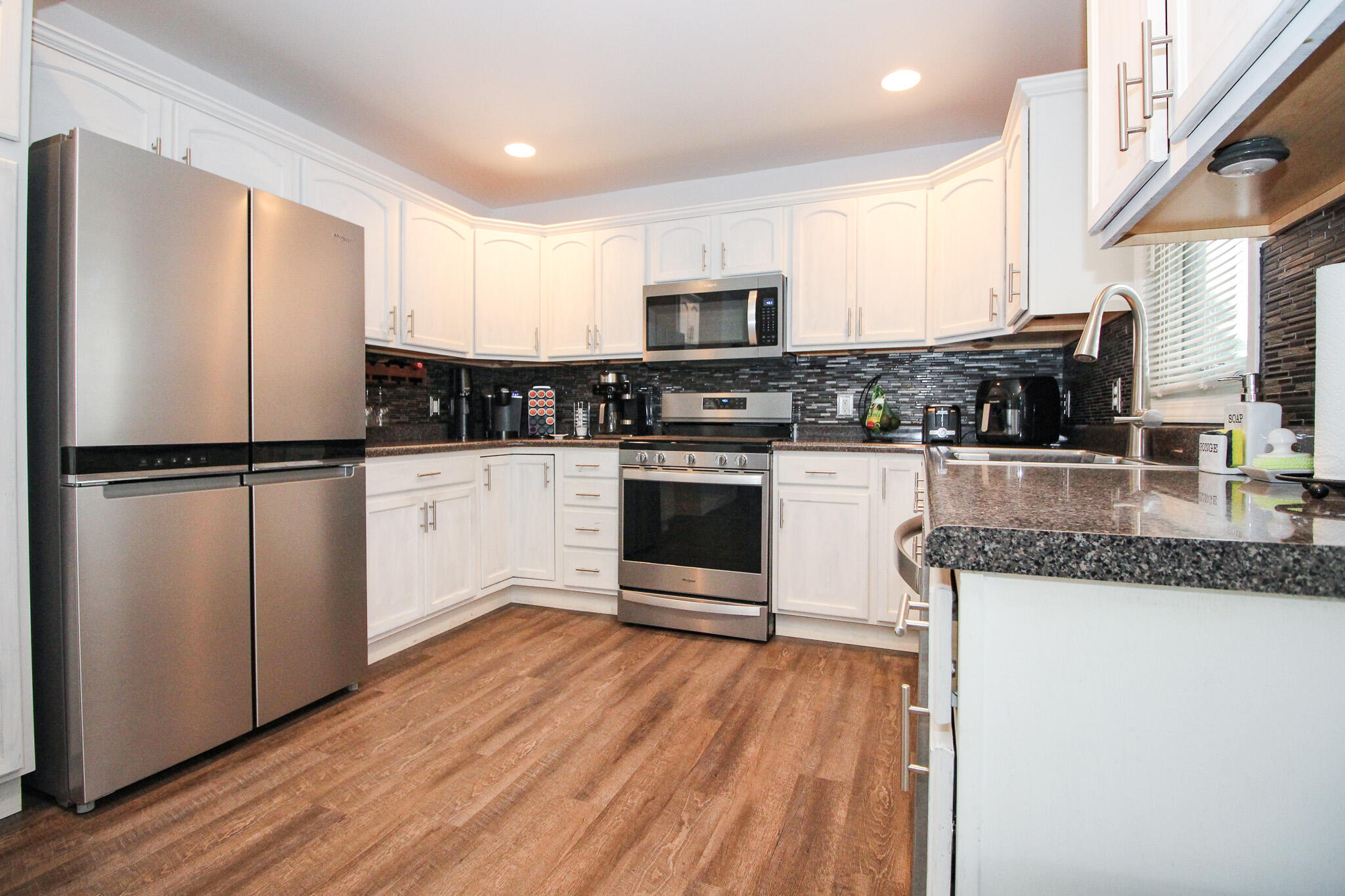 1403 Edgewater Road Crown Point, IN 46307 - Photo 9 of 43 a kitchen with stainless steel appliances granite countertop a refrigerator a stove top oven and sink