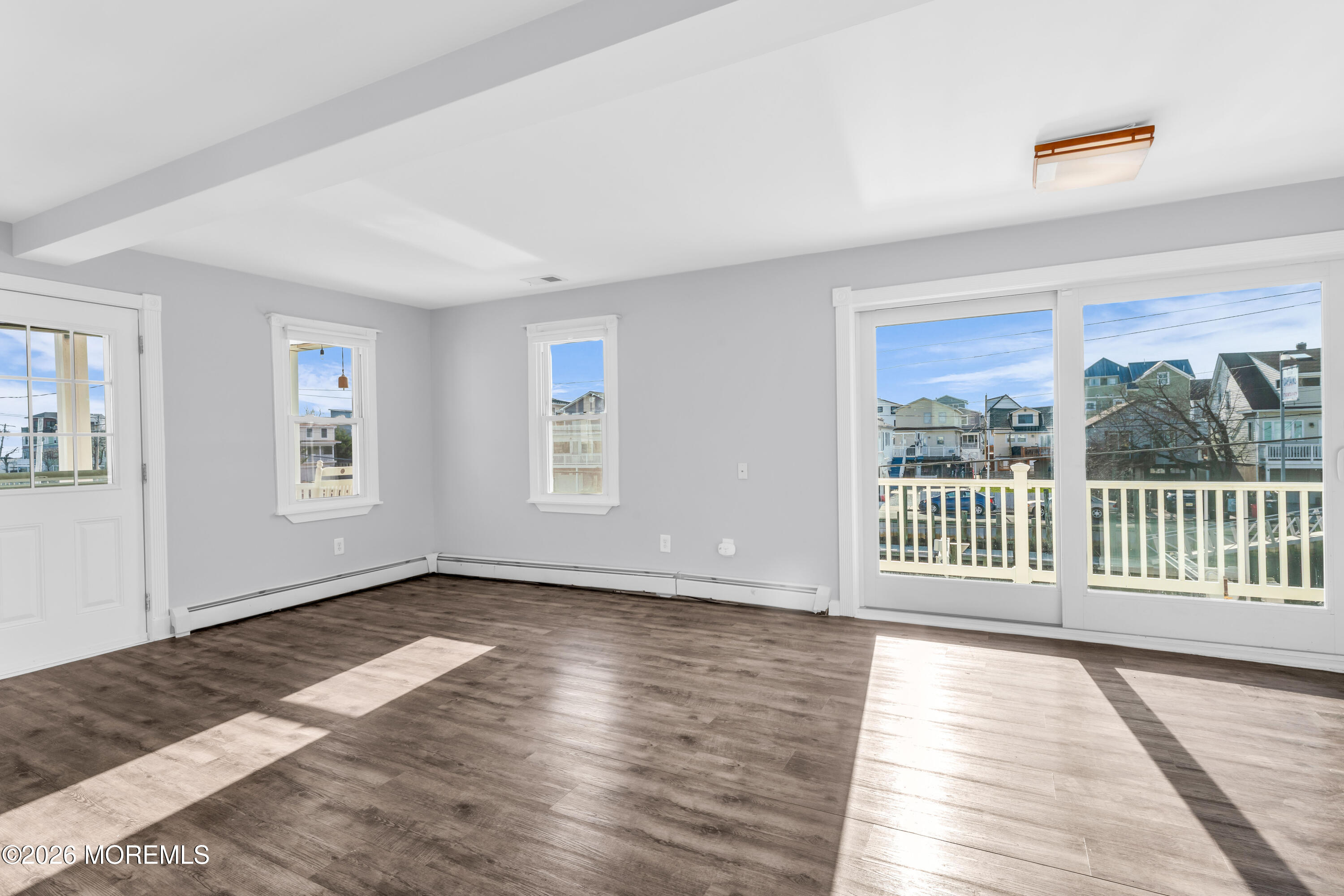 2 Bedle Place Highlands, NJ 07732 - Photo 4 of 25 a view of an empty room with wooden floor and a window