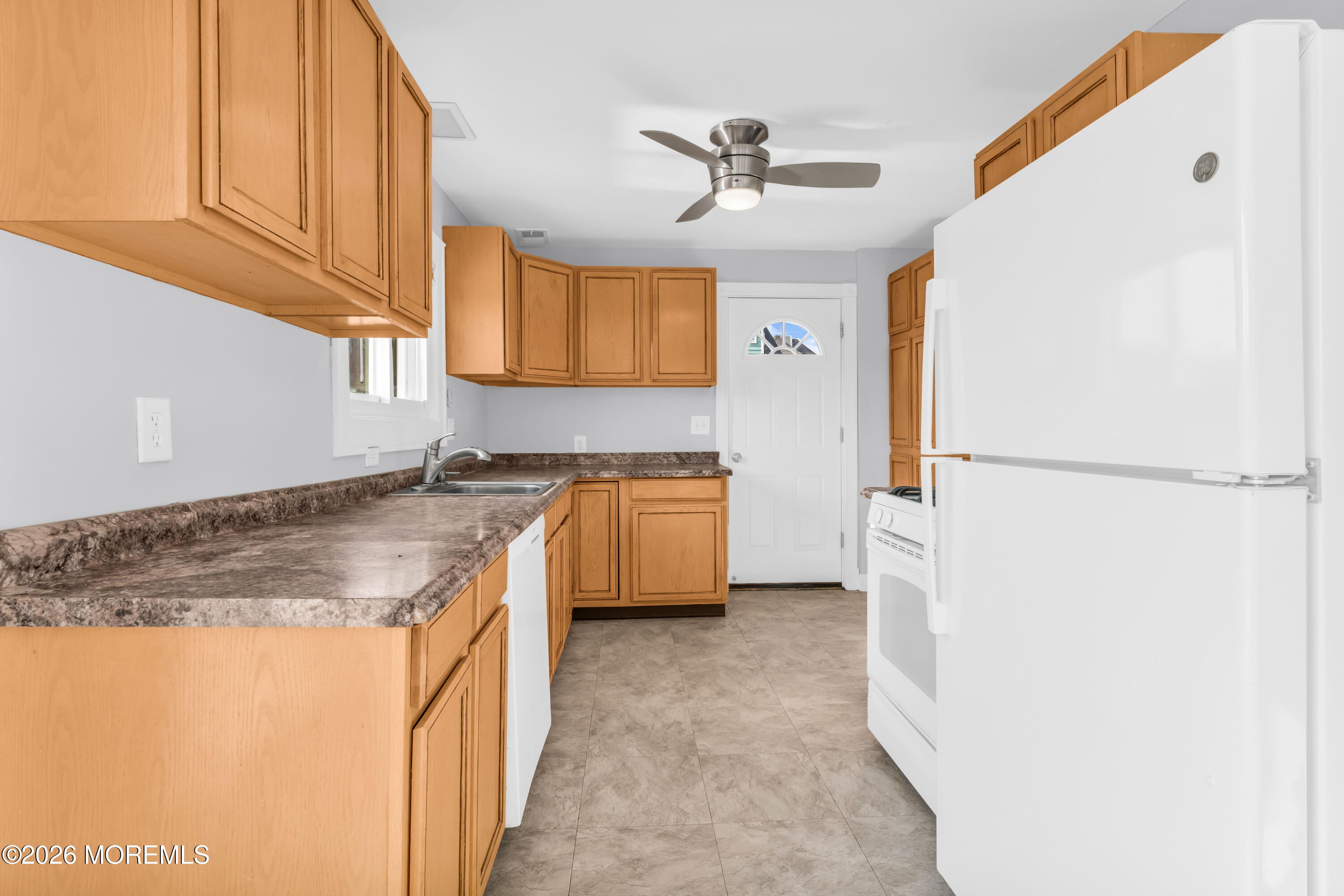 2 Bedle Place Highlands, NJ 07732 - Photo 9 of 25 a kitchen with stainless steel appliances granite countertop a sink a stove a refrigerator a washer dryer and white cabinets