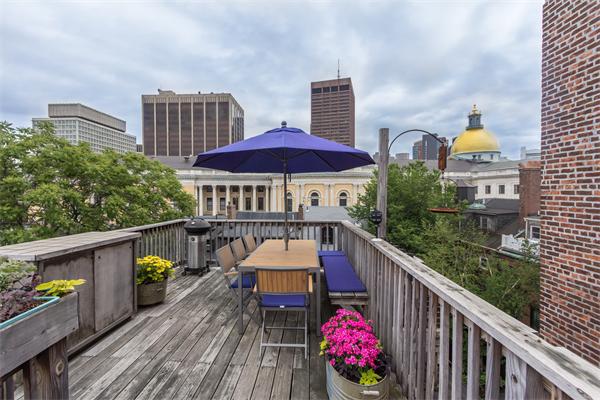 9 Joy Street, Unit 3 Boston, MA 02114 - Photo 14 of 16 a view of a balcony with chairs and wooden floor