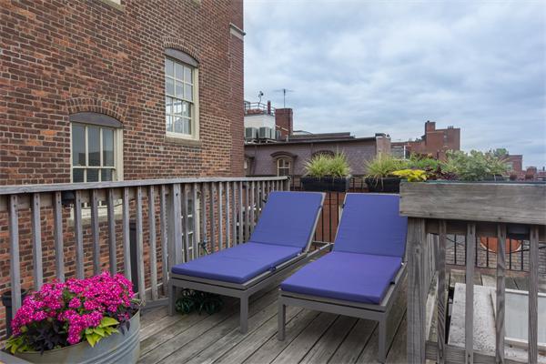 9 Joy Street, Unit 3 Boston, MA 02114 - Photo 16 of 16 a wooden bench sitting in front of a building