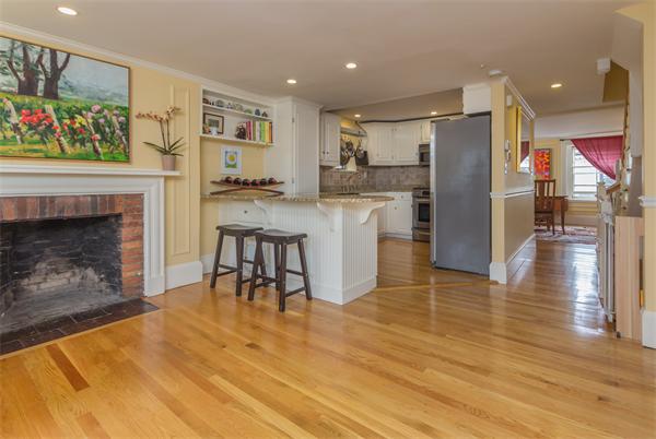 9 Joy Street, Unit 3 Boston, MA 02114 - Photo 2 of 16 a kitchen with stainless steel appliances granite countertop a refrigerator and a fireplace