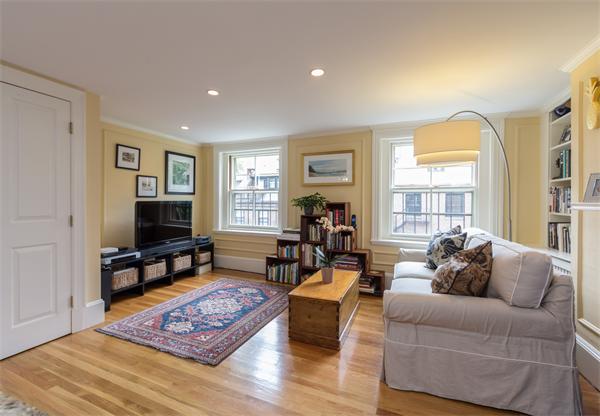 9 Joy Street, Unit 3 Boston, MA 02114 - Photo 5 of 16 a living room with furniture and a flat screen tv