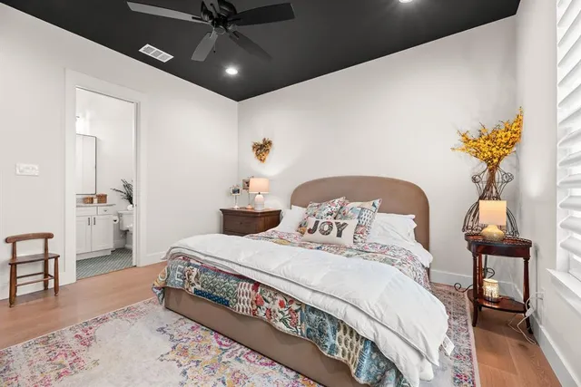 a spacious bedroom with a bed and a chandelier