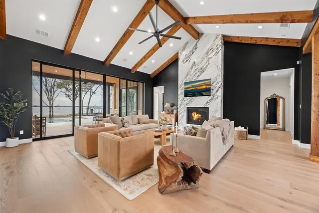 a living room with furniture a large window and a fireplace