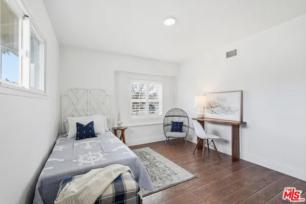 a living room with furniture window and a wooden floor