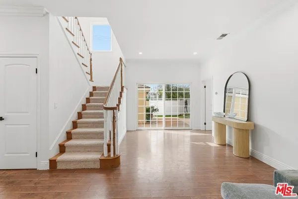 a living room with furniture large window and fireplace