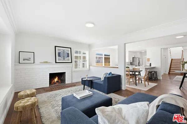 a living room with furniture wooden floor and a table