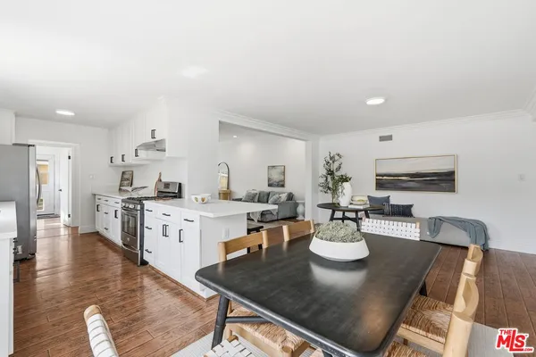 a kitchen with stainless steel appliances a sink stove and cabinets