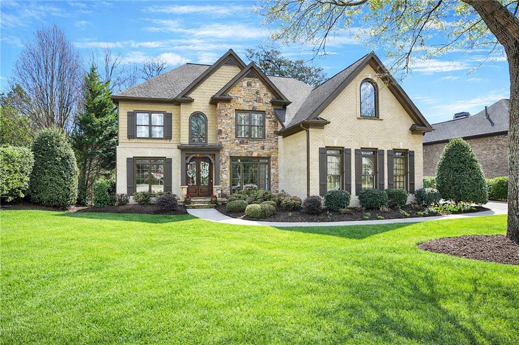 a front view of a house with a yard and porch