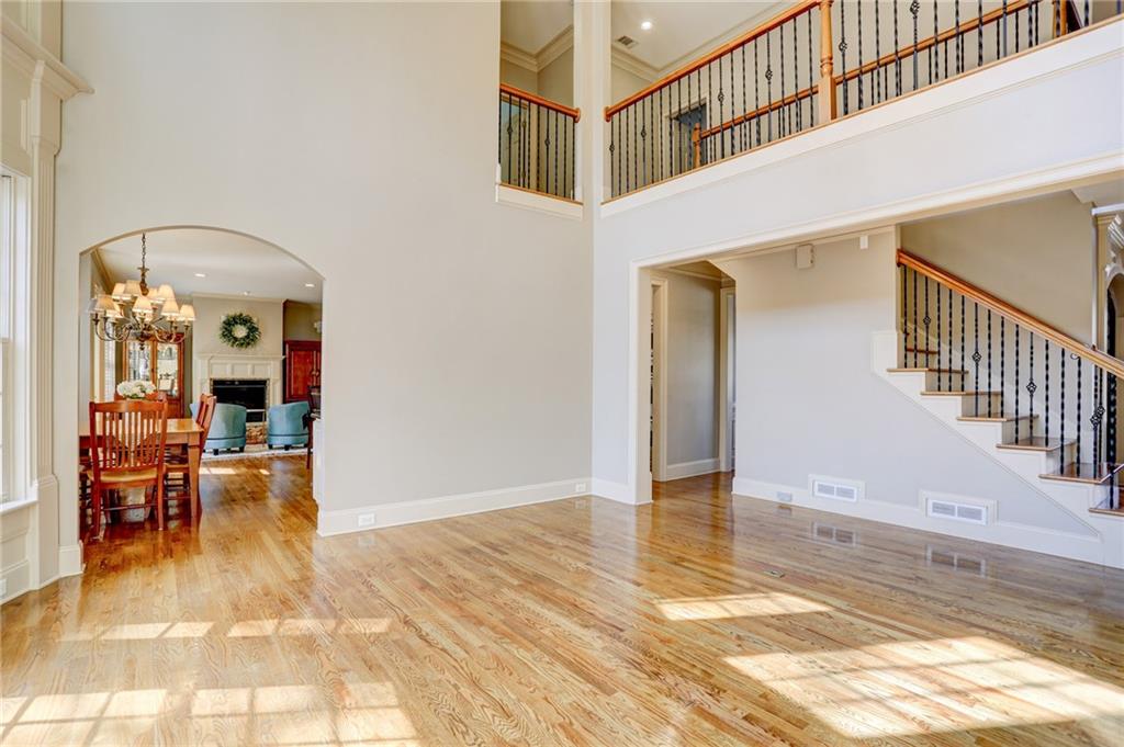 11015 Callington Court Suwanee, GA 30024 - Photo 14 of 87 a view of a hallway with wooden floor and a living room