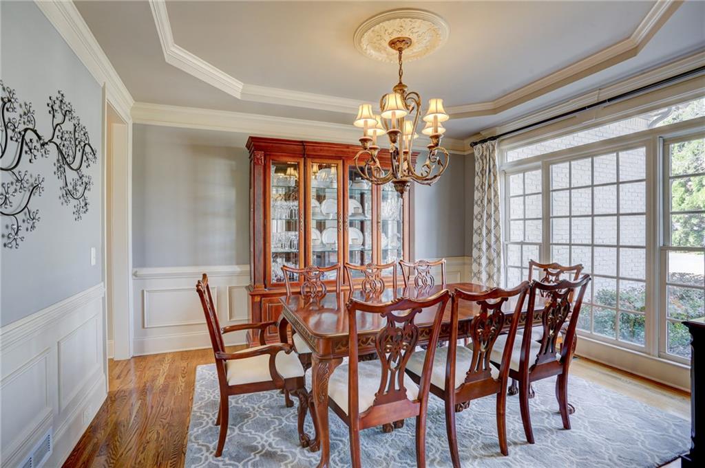 11015 Callington Court Suwanee, GA 30024 - Photo 16 of 87 a view of a dining room with furniture a chandelier and wooden floor