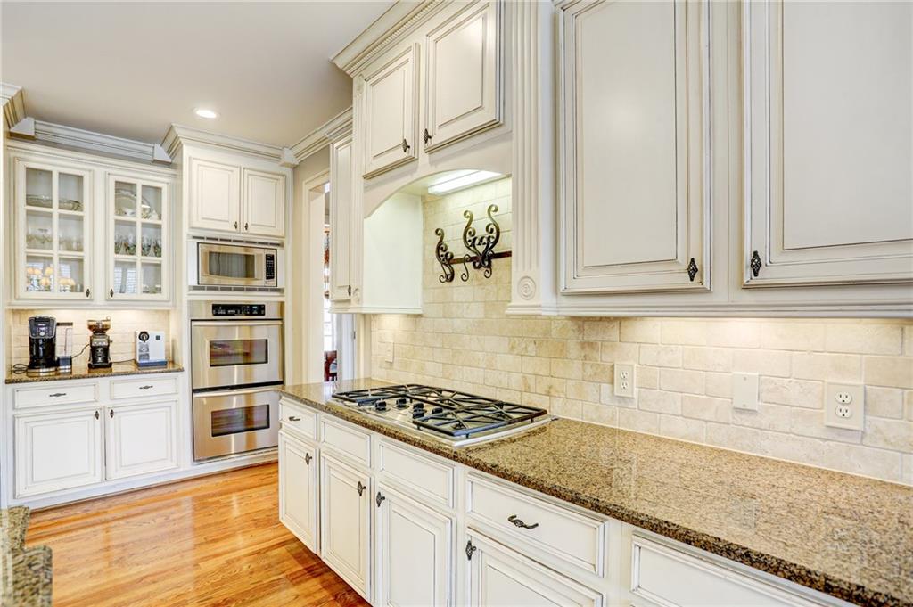11015 Callington Court Suwanee, GA 30024 - Photo 20 of 87 a kitchen with stainless steel appliances granite countertop a sink and cabinets
