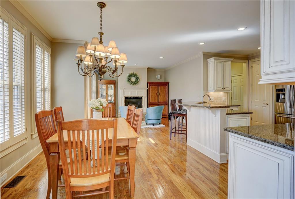 11015 Callington Court Suwanee, GA 30024 - Photo 25 of 87 a dining room filled chandelier and wooden floor