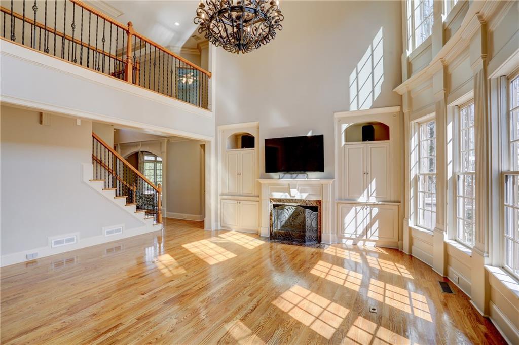 11015 Callington Court Suwanee, GA 30024 - Photo 3 of 87 a view of a livingroom with wooden floor and a flat screen tv