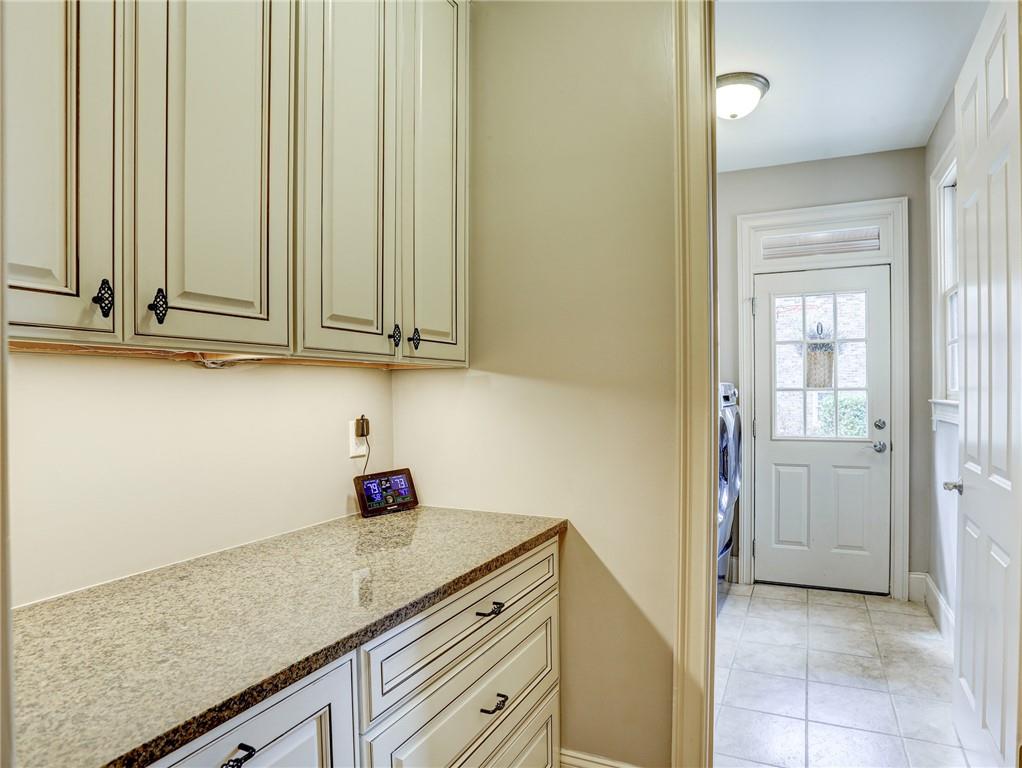 11015 Callington Court Suwanee, GA 30024 - Photo 31 of 87 a kitchen with stainless steel appliances granite countertop white cabinets and a granite counter tops