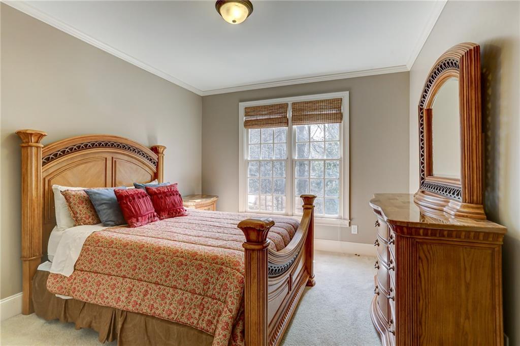 11015 Callington Court Suwanee, GA 30024 - Photo 39 of 87 a bedroom with a bed and wooden floor