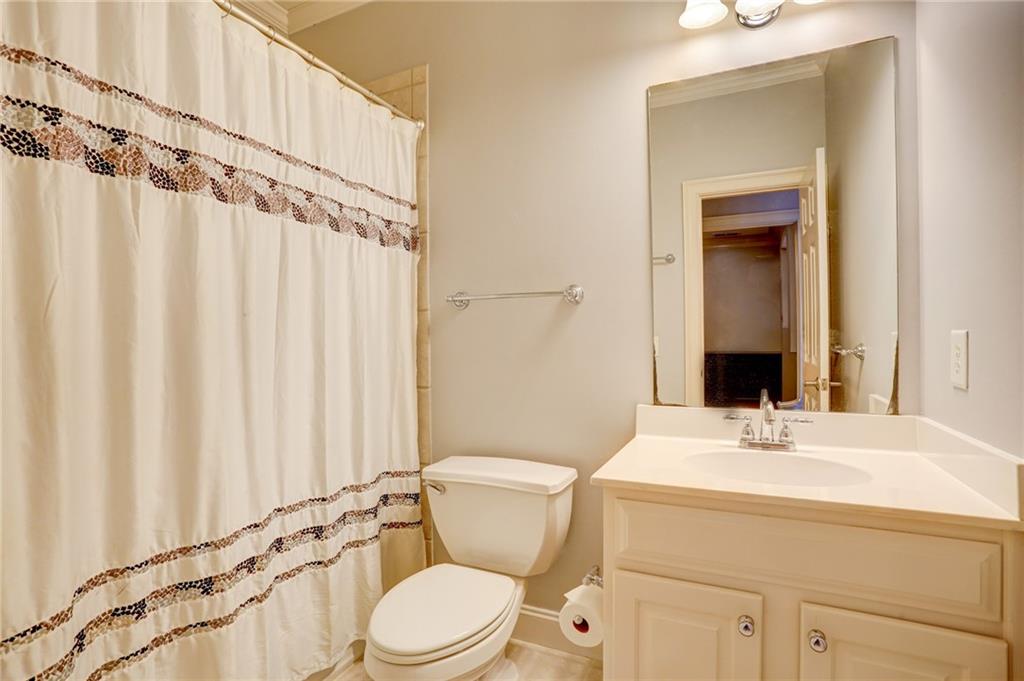 11015 Callington Court Suwanee, GA 30024 - Photo 40 of 87 a bathroom with a sink a toilet and shower curtain