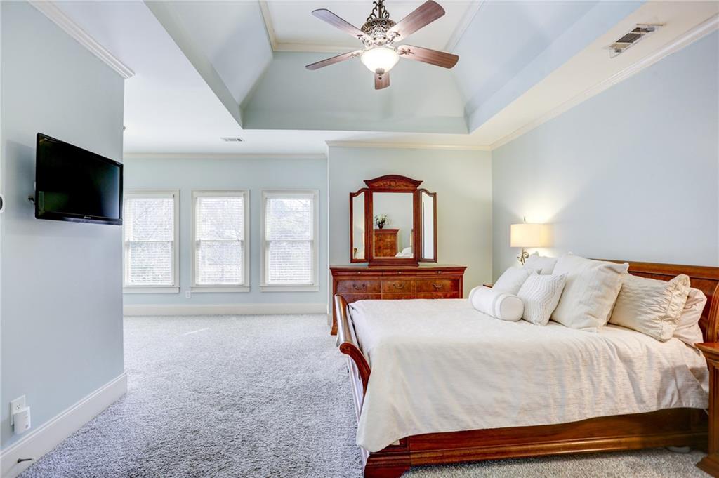 11015 Callington Court Suwanee, GA 30024 - Photo 46 of 87 a bedroom with a bed and a flat screen tv