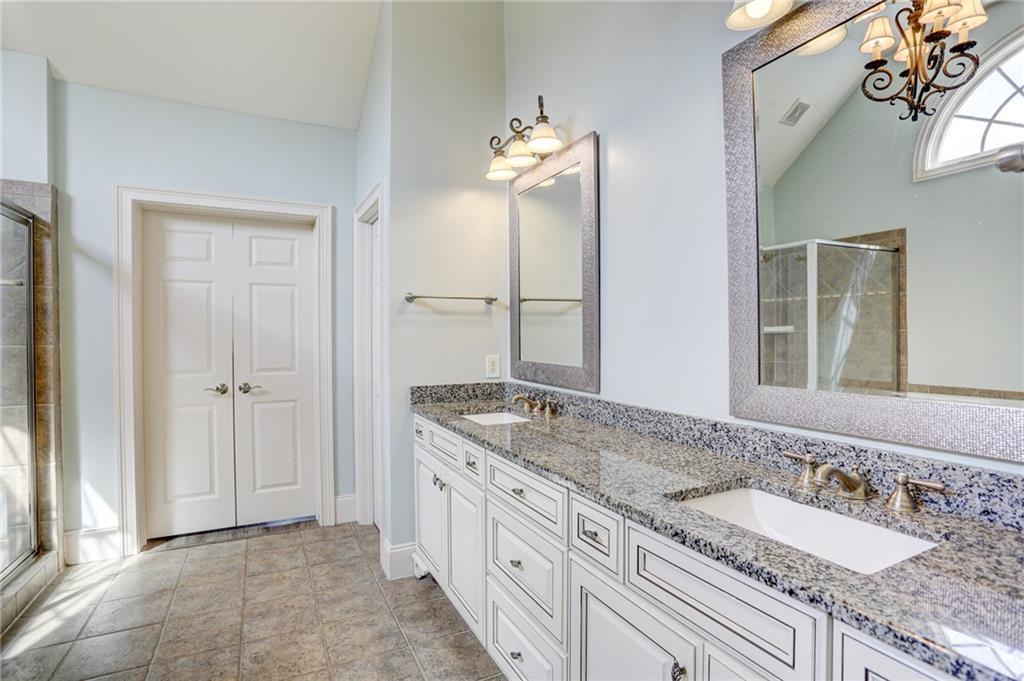 11015 Callington Court Suwanee, GA 30024 - Photo 50 of 87 a bathroom with a granite countertop double vanity sink and a mirror