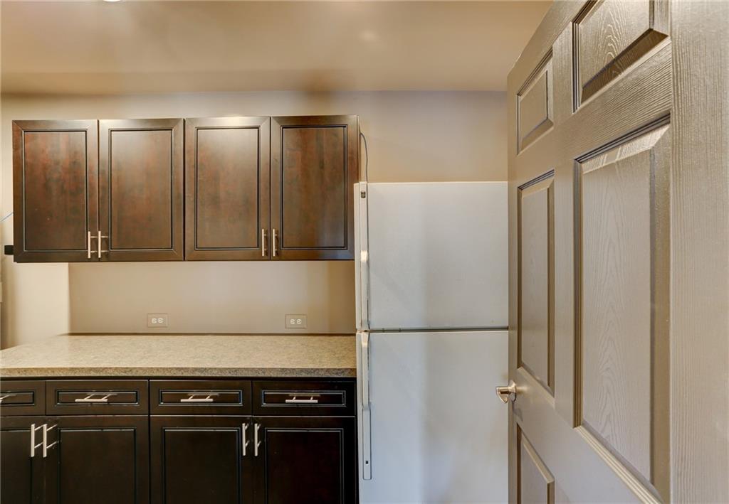 11015 Callington Court Suwanee, GA 30024 - Photo 70 of 87 a kitchen with a refrigerator and cabinets