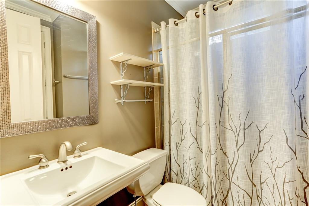 11015 Callington Court Suwanee, GA 30024 - Photo 71 of 87 a bathroom with a sink toilet and shower