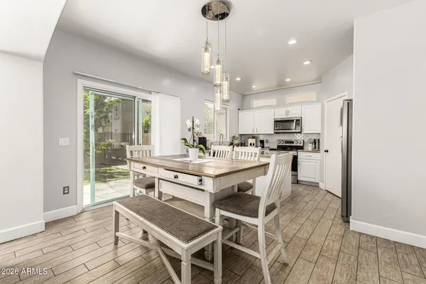 a kitchen with kitchen island granite countertop a sink cabinets and wooden floor