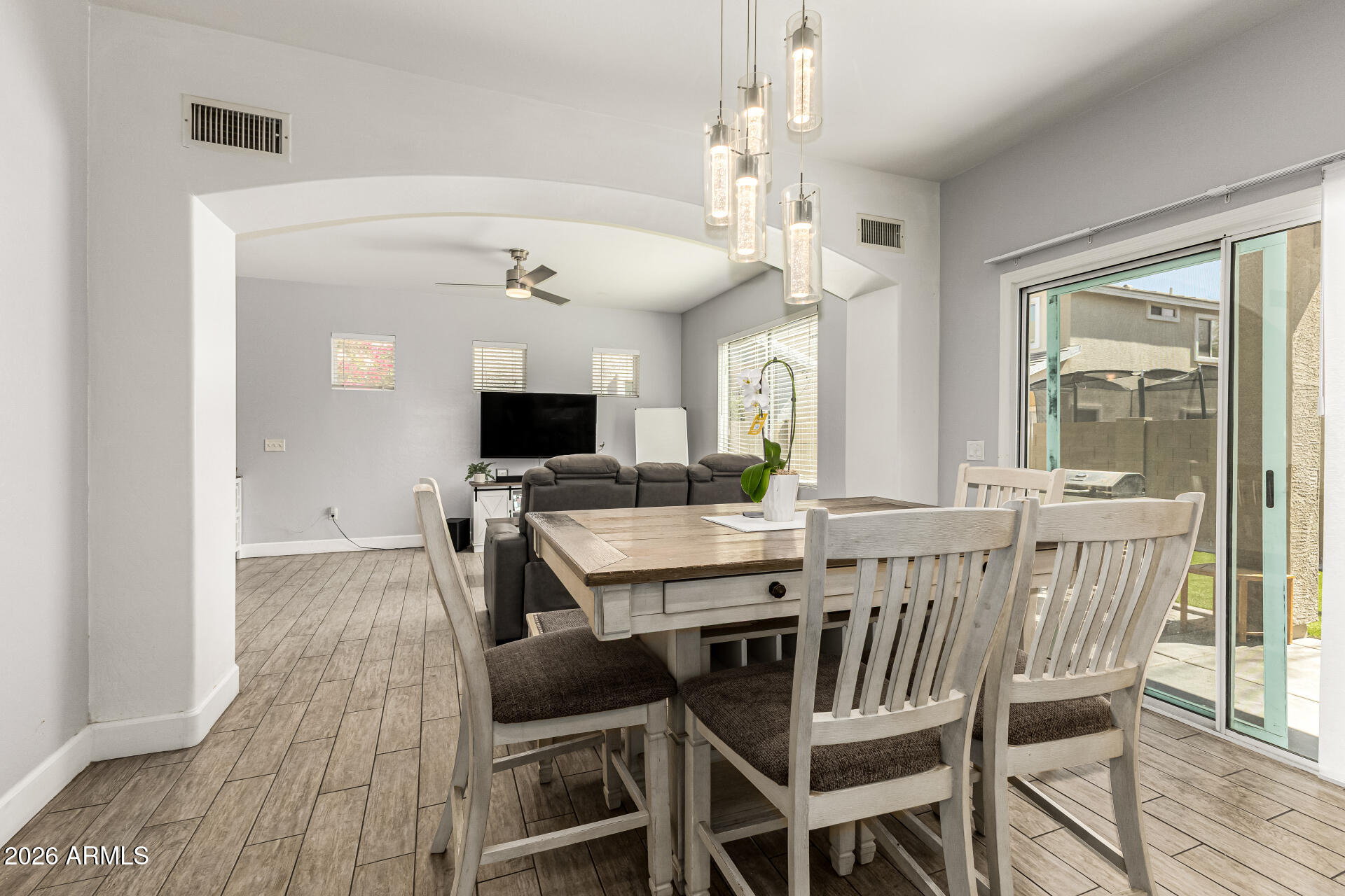 4237 East Orchid Lane Gilbert, AZ 85296 - Photo 12 of 33 a view of a dining room with furniture window and wooden floor