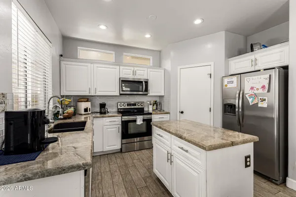 a kitchen with a sink stove and refrigerator