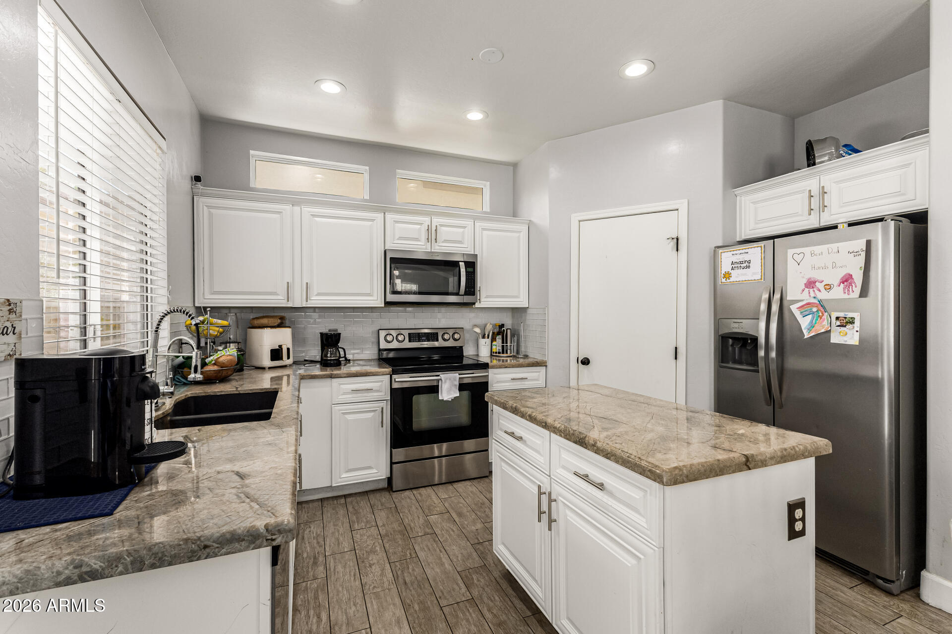 4237 East Orchid Lane Gilbert, AZ 85296 - Photo 13 of 33 a kitchen with a sink stove and refrigerator