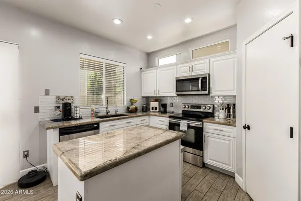 a kitchen with a sink stove and microwave